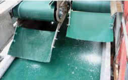 Green PVC smooth conveyor belt from TACT Industrial Products, designed for MRO conveyor belting applications.