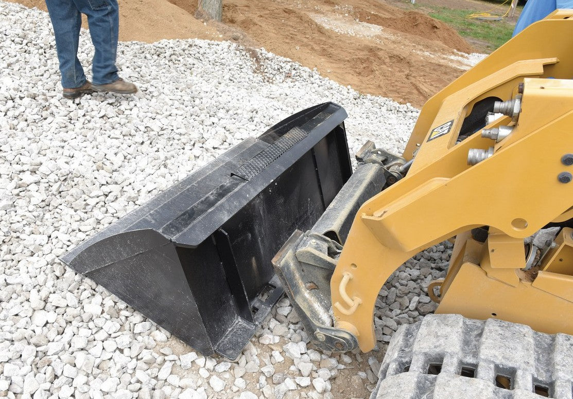 Rear view of a Vestil skid steer bucket attachment for heavy machinery, showcasing the durable metal construction and mounting points.