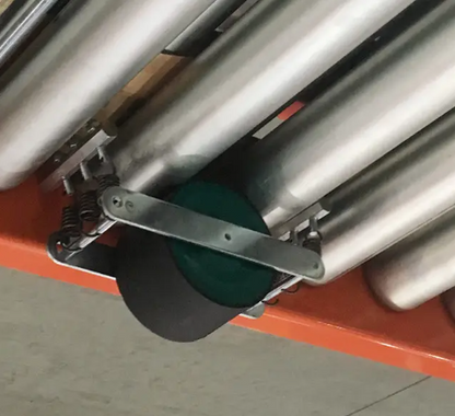 Green pallet brake roller from TACT Industrial Products for speed control in material handling and pallet transportation.